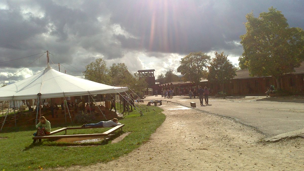 On this picture one can see the sun breaking through the clouds after a storm. The people are leaving there shelters to continue there activities and to enjoy the peacefull atmosphere of the place. Location: Taizé, France.