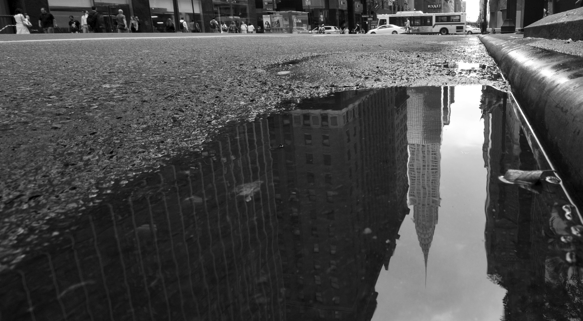 Reflection of the Chrysler Building in a puddle